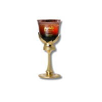 Close-up of Arabiyat Prestige La Di Da perfume glass on gold stand