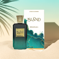 Khadlaj Island – Tropical Coconut & Amber Perfume with box on sandy surface, highlighting the exotic design and premium fragrance packaging.