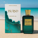 Khadlaj Island – Tropical Coconut & Amber Perfume displayed on a beach with turquoise ocean, featuring elegant green bottle and artistic box.