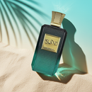 Khadlaj Island – Tropical Coconut & Amber Perfume bottle lying on sand under sunlight, emphasizing its tropical elegance and golden label.