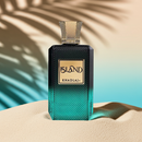 Khadlaj Island – Tropical Coconut & Amber Perfume bottle on sand with palm shadow, showcasing its luxurious gold cap and textured green glass.